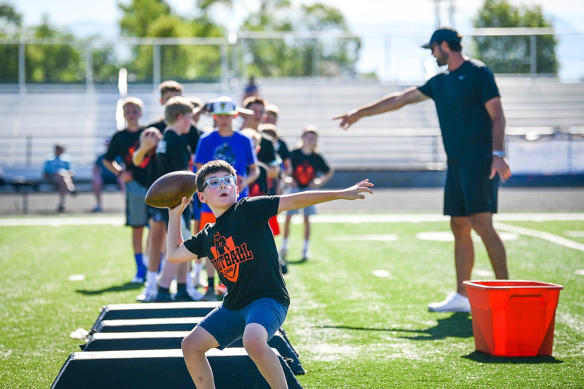 A young camper throws a pass as former NFL and Flathead Braves quarterback Brock Osweiler leads quarterback drills during a pair of free football camps hosted by Osweiler at Legends Stadium in Kalispell on Saturday, July 1. (Casey Kreider/Daily Inter Lake)