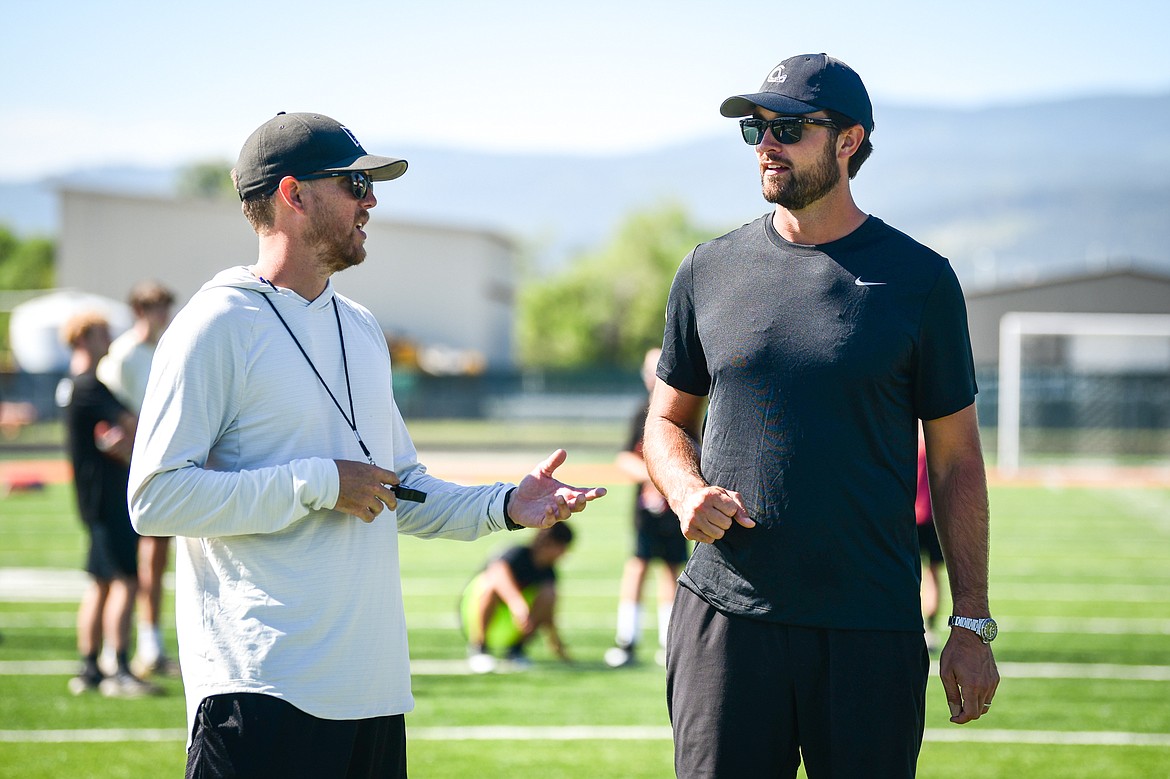 Former NFL and Flathead Braves quarterback Brock Osweiler talks with Flathead head coach Caleb Aland during a pair of free football camps hosted by Osweiler at Legends Stadium in Kalispell on Saturday, July 1. (Casey Kreider/Daily Inter Lake)