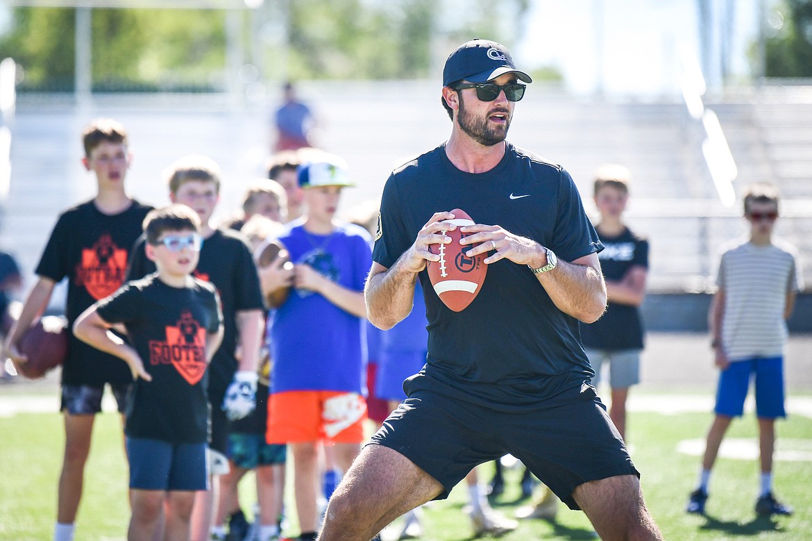 Former NFL and Flathead Braves quarterback Brock Osweiler leads quarterback drills during a pair of free football camps hosted by Osweiler at Legends Stadium in Kalispell on Saturday, July 1. (Casey Kreider/Daily Inter Lake)