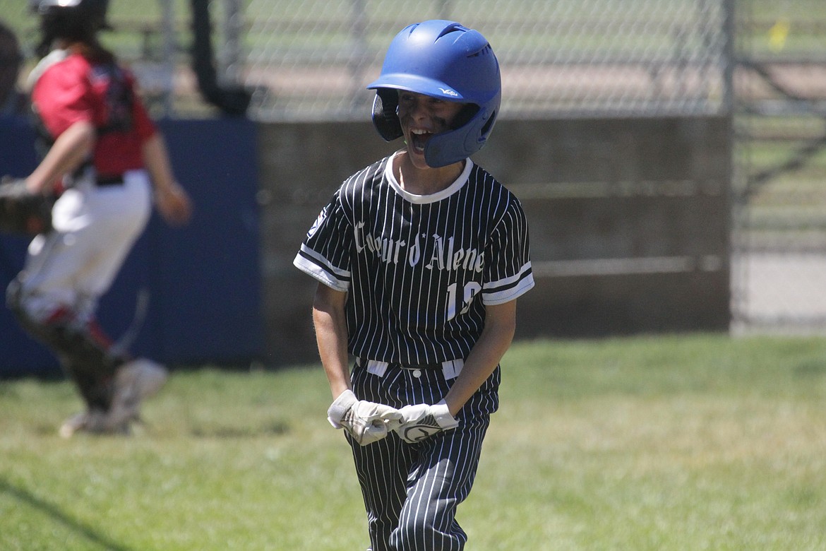 MARK NELKE/Press
Nolan Goetz of Coeur d'Alene celebrates after scoring a run against Hayden during an Idaho Little League District 1 11U tournament game Saturday at Canfield Sports Complex in Coeur d'Alene.