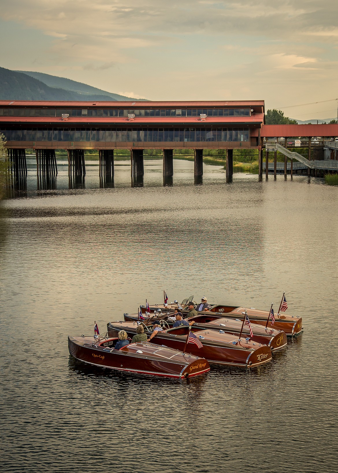A quartet of wooden boat owners stop for a visit on Sand Creek during a past Sandpoint Boat Show.
