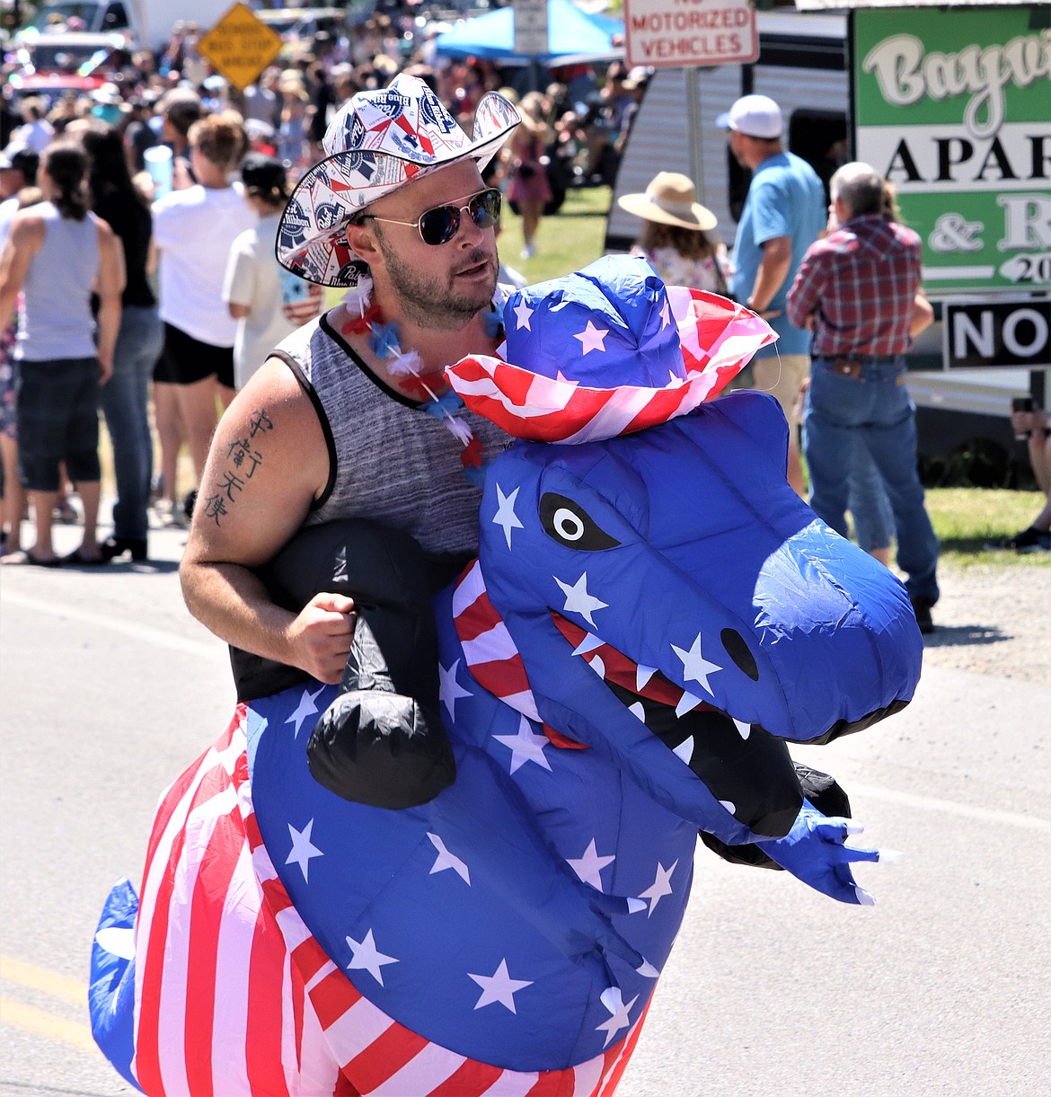 Aaron Willrich wears a red, white and blue dinosaur outfit for the Bayview Daze parade on Saturday.