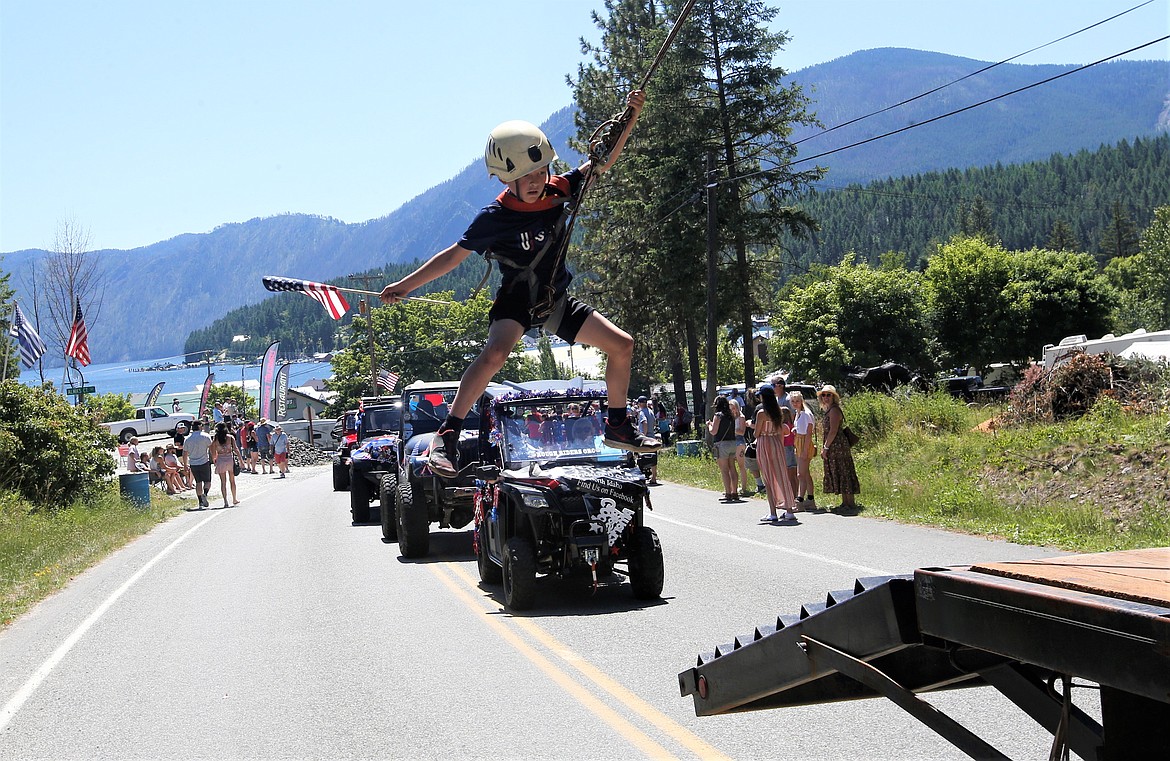 Sam Noble swings along with the Noble Tree Service entry in the Bayview Daze parade.