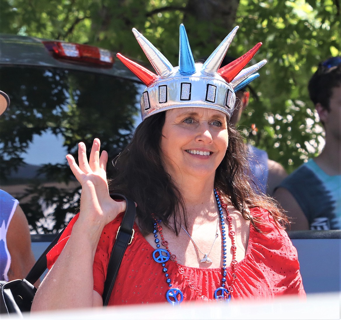 Kim Ward wears a Statue of Liberty cap as she waves and watches the Bayview Daze parade on Saturday.