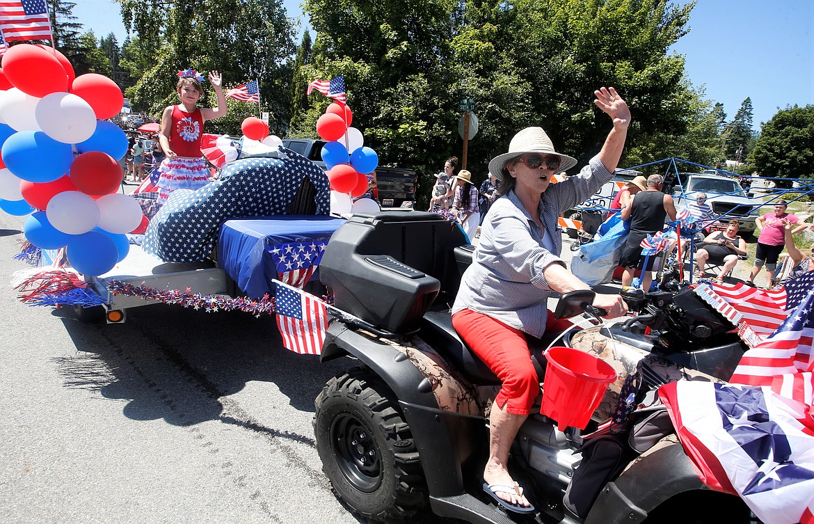 Kim Poage waves as she rides an ATV in the Bayview Daze parade.