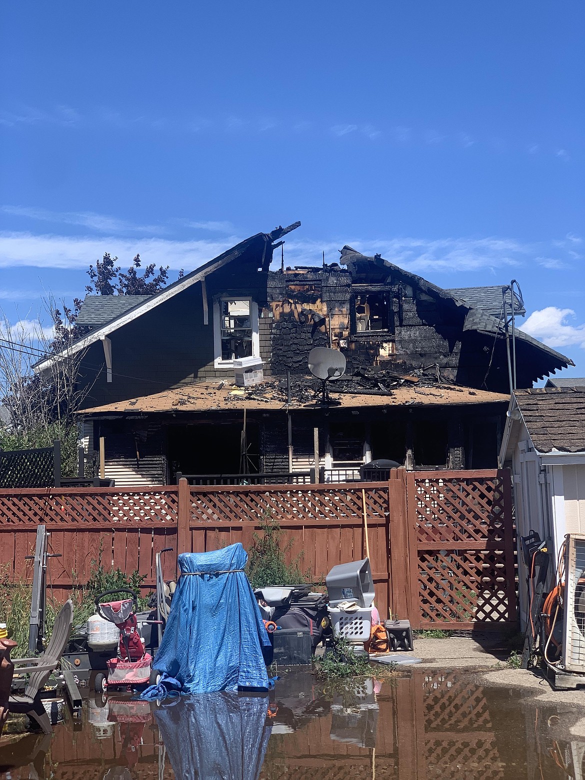 A blaze destroyed a multi-residential home on Second Street West in Kalispell Saturday night. Kalispell Fire Department firefighters remained to monitor the scene through Sunday, June 2. (Hilary Matheson/Daily Inter Lake)