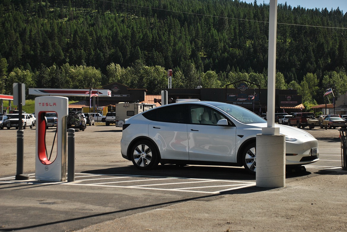 A Tesla charges up at the brand new electric vehicle charging station across the road from the St. Regis Travel Center and Gift Shop. A Tesla Supercharger station can charge up a car in 15 minutes and go for a 200 mile range. (Mineral Independent/Amy Quinlivan)