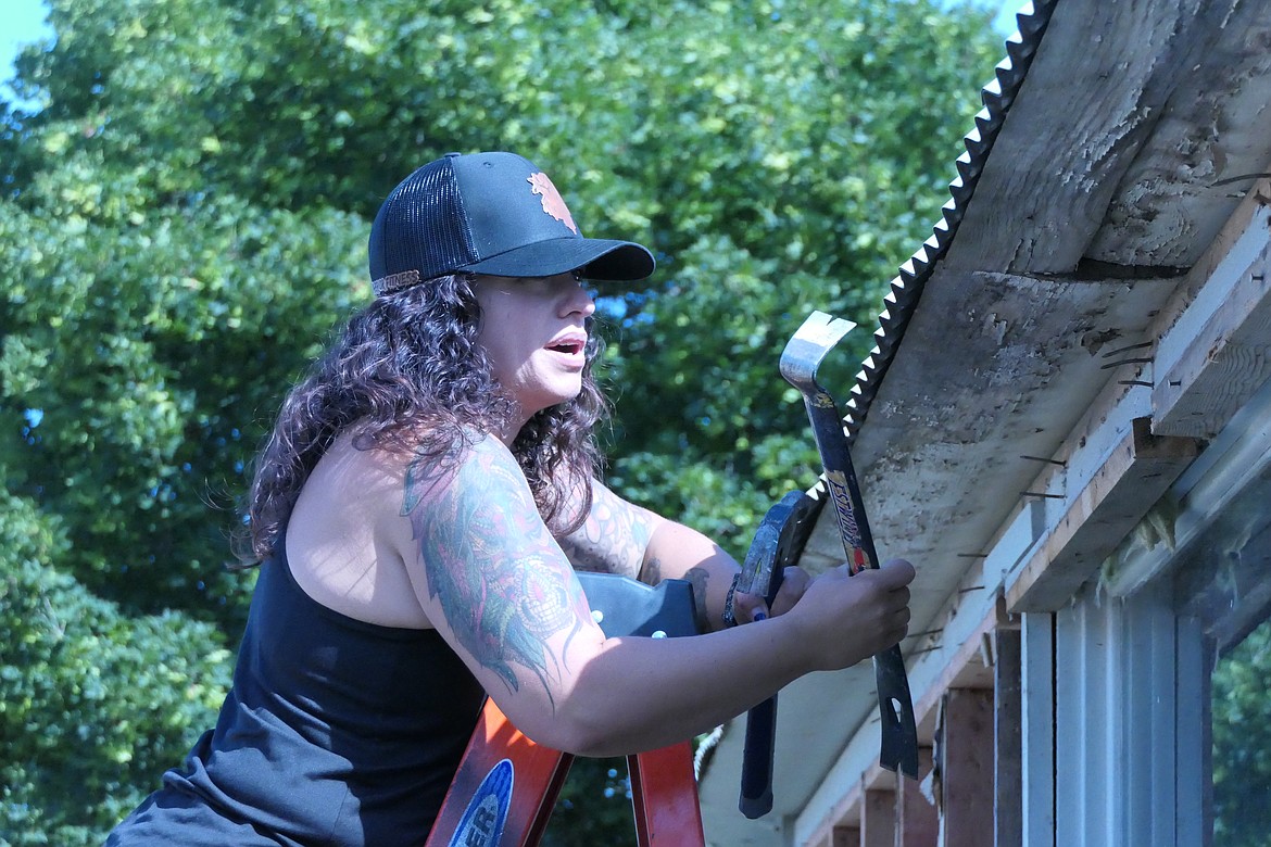 Business owner Becky Fields works on the roof of the building that will house her Warrior Fitness gym when it opens this summer in Plains.  The gym is in the Quon-set hut building that was once housed by the town's eye doctor. (Chuck Bandel/VP-MI)