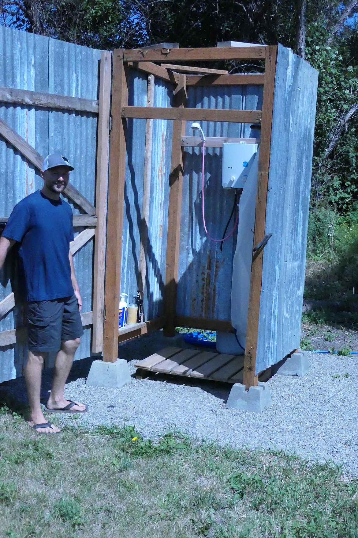 Bridger Gaul demonstrates on the outdoor shower stalls with hot and cold running water. (Chuck Bandel/VP-MI)