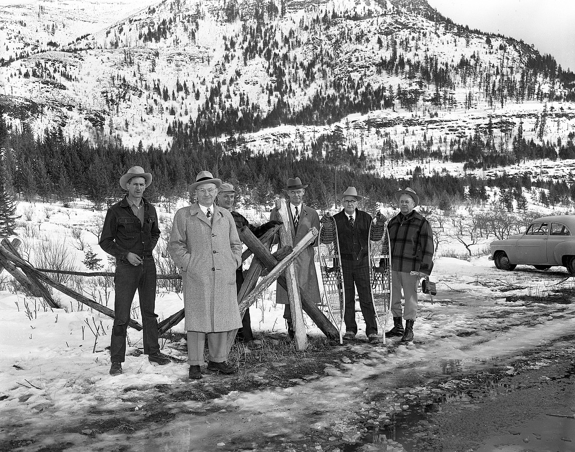 Anaconda Copper Mining brass scout out locations for a new aluminum plant on Jan. 31, 1952. Here they are on the old John Schandler orchard at the base of Teakettle Mountain. From left is Henry Larkin, one of the landowners, H.G. Satterthwaite, assistant general superintendent of ACM, Joe Opalka, V.E. Christensen of International Smelting Co., W.C. Rae of ACM and Dwight Lohn, Bank of Columbia Falls vice president. (Mel Ruder photo)