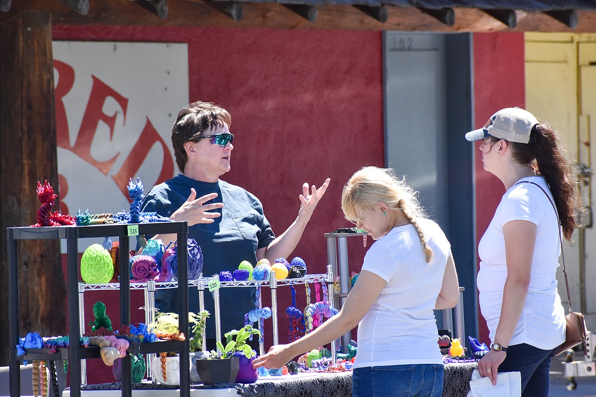 Vendors interacted with festival attendees, talking about their goods or services and sharing conversation.