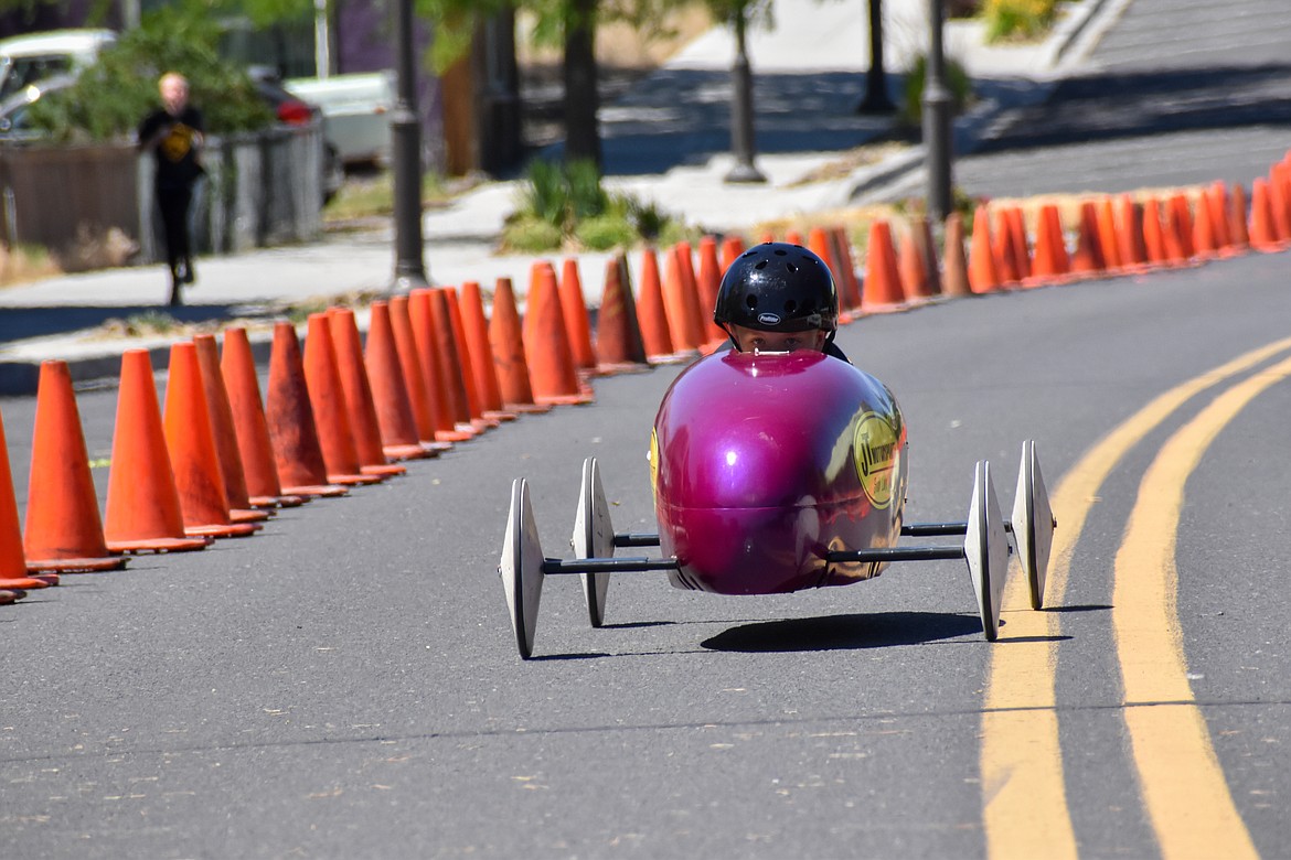 In order to go as fast as possible, children in the soap box races leaned forward in their cars to have the least resistance as possible.