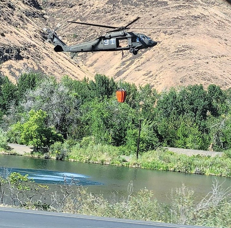 A YTC Roter 292 fills its bucket on July 2 at Rotary Lake to help combat the Rest Haven Road fire near Selah.