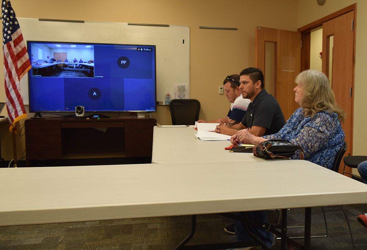 Hatton Town Clerk Jared Potts, Othello Food Bank Lead Facilities Manager Jose Garza and Dory Wilson, a citizen from Lind, sit down to request support from the Adams County Board of Commissioners during last Wednesday’s regular meeting.