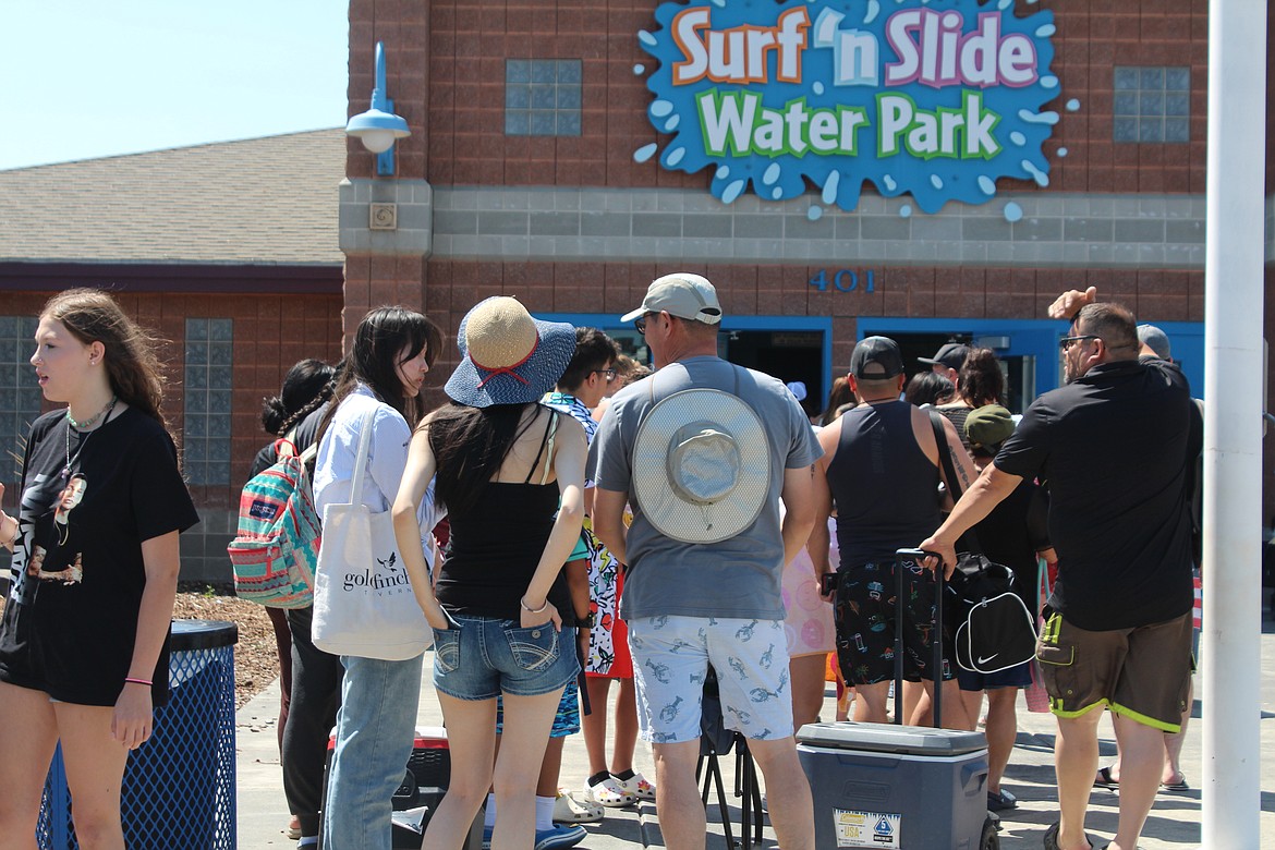 Holiday crowds wait in line outside the Surf ‘n Slide Water Park in Moses Lake right after opening Monday. Hot weather is forecast for the rest of the week, making the pool an attractive spot.