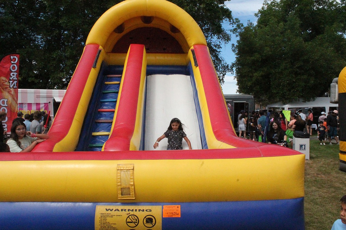 A girl slides down an inflatable slide at last year’s Summerfest in Royal City. This year’s event is Friday and Saturday.