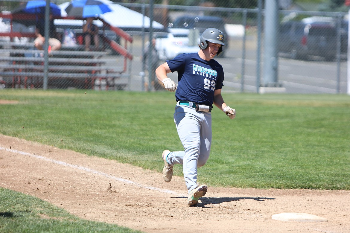 River Dog right fielder Evan Smith arrives at first base after recording a hit against Absolute Human Performance Academy on Friday.