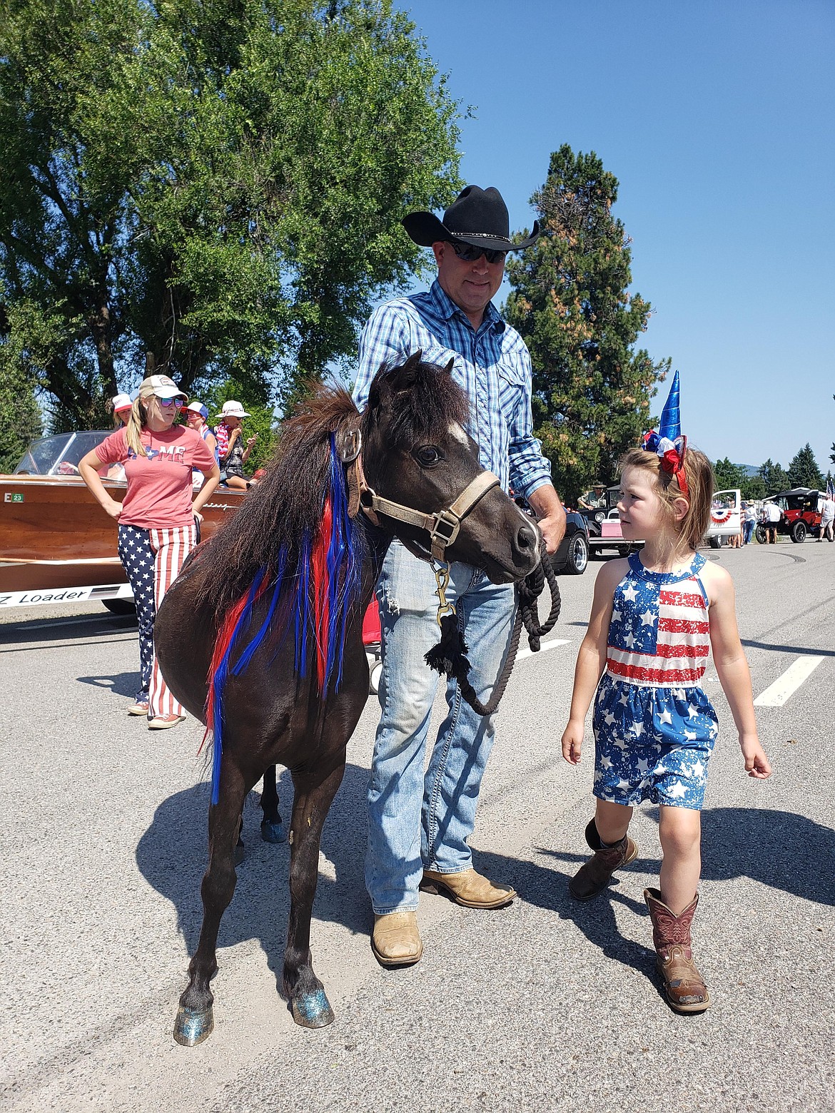 Rathdrum Parks and Recreation Director Eric Singer with Maddie Ellison prepare to march in the Spirit Lake Old Fashioned Fourth of July Parade.