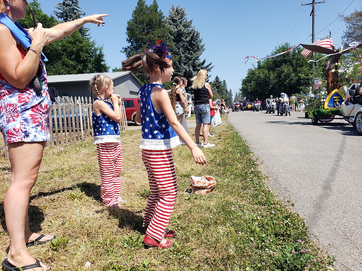 Bexley and Aylla Towe spin with excitement during the Spirit Lake Fourth of July Parade.