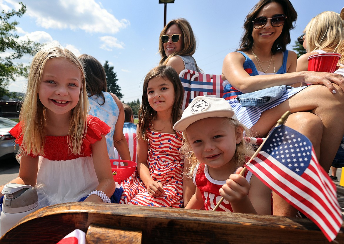 A group of patriotic young float riders participate in the Bigfork 4th of July Parade Tuesday. (Jeremy Weber/Daily Inter Lake)