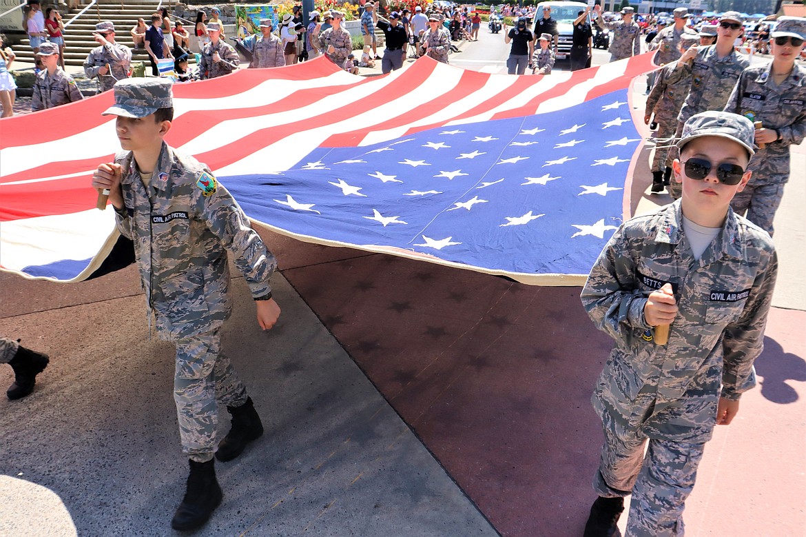 Civil Air Patrol members carry a giant flag in the Fourth of July parade on Tuesday in Coeur d'Alene.