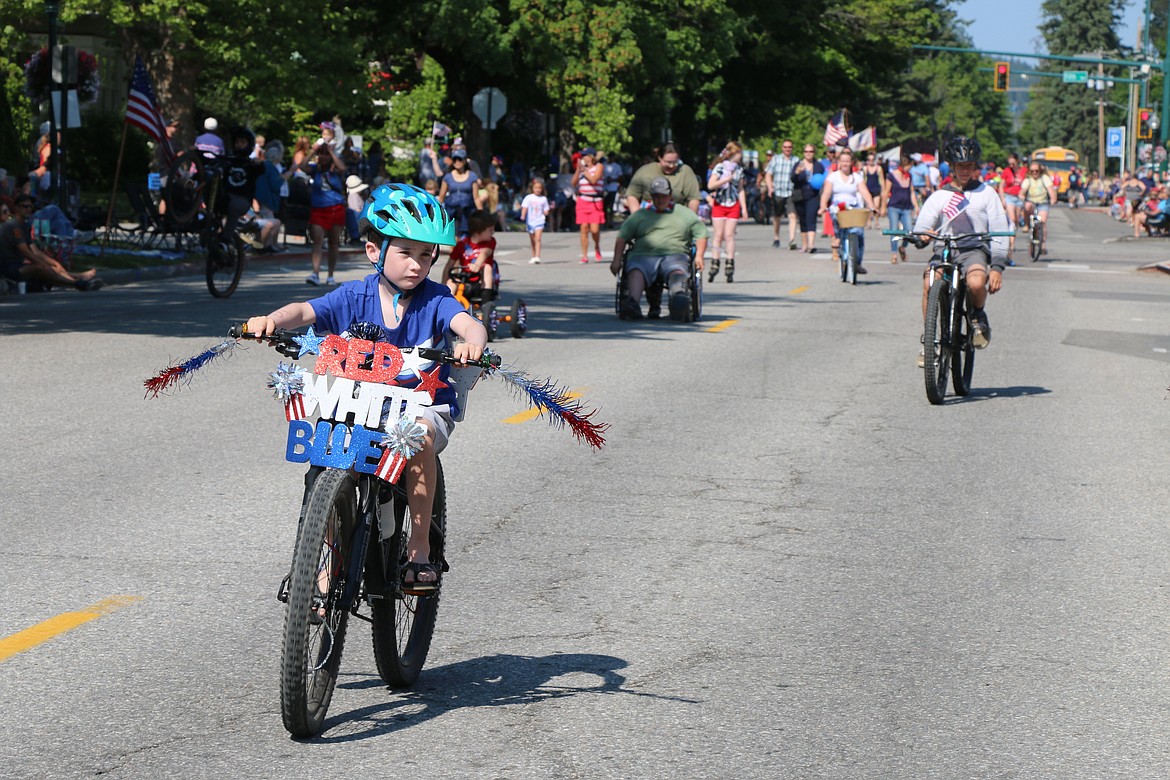 A young bicycle rider leads the pack during the Sandpoint Lions kids parade on the Fourth of July on Tuesday.