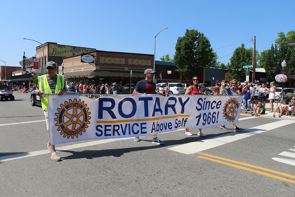 Members of the Sandpoint Rotary make their way through downtown Sandpoint on Tuesday during the Sandpoint Lions' grand parade.