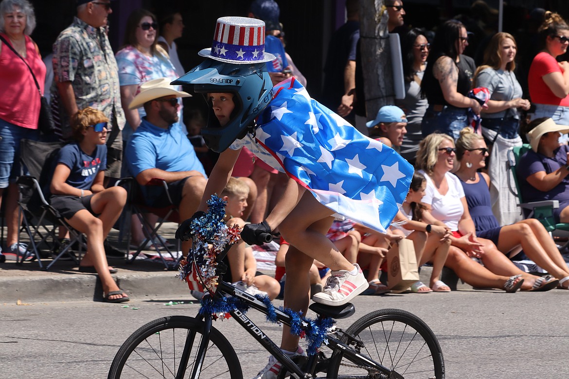 Riley Crebs rides with the Cherry Hill BMX bike group in the Fourth of July parade on Tuesday in Coeur d'Alene.