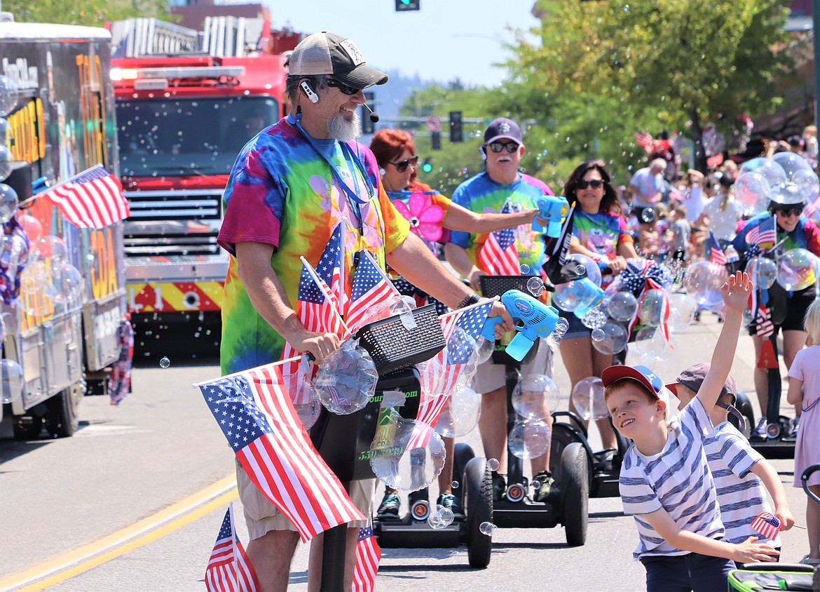 Scott Freier with the Tour CDA entry showers children with bubbles in Tuesday's Fourth of July parade on Tuesday in Coeur d'Alene.