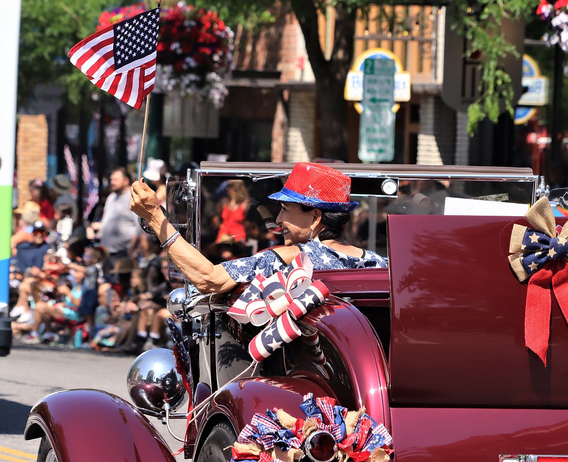 Rita Case waves as she rides in the Fourth of July parade on Tuesday in Coeur d'Alene.