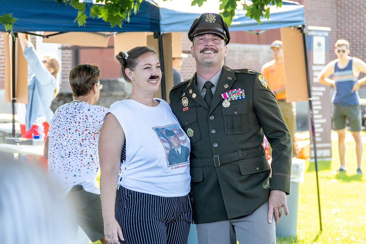 Thompson and his wife, Dayna, who is sporting Thompson's signature mustache and a T-shirt with his basic training photo on it.