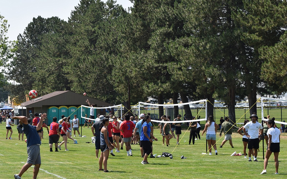 A participant in the Fourth of July Volleyball Tournament, a line of volleyball games hosted by O-Town Volleyball, serves the ball to the opposing team.
