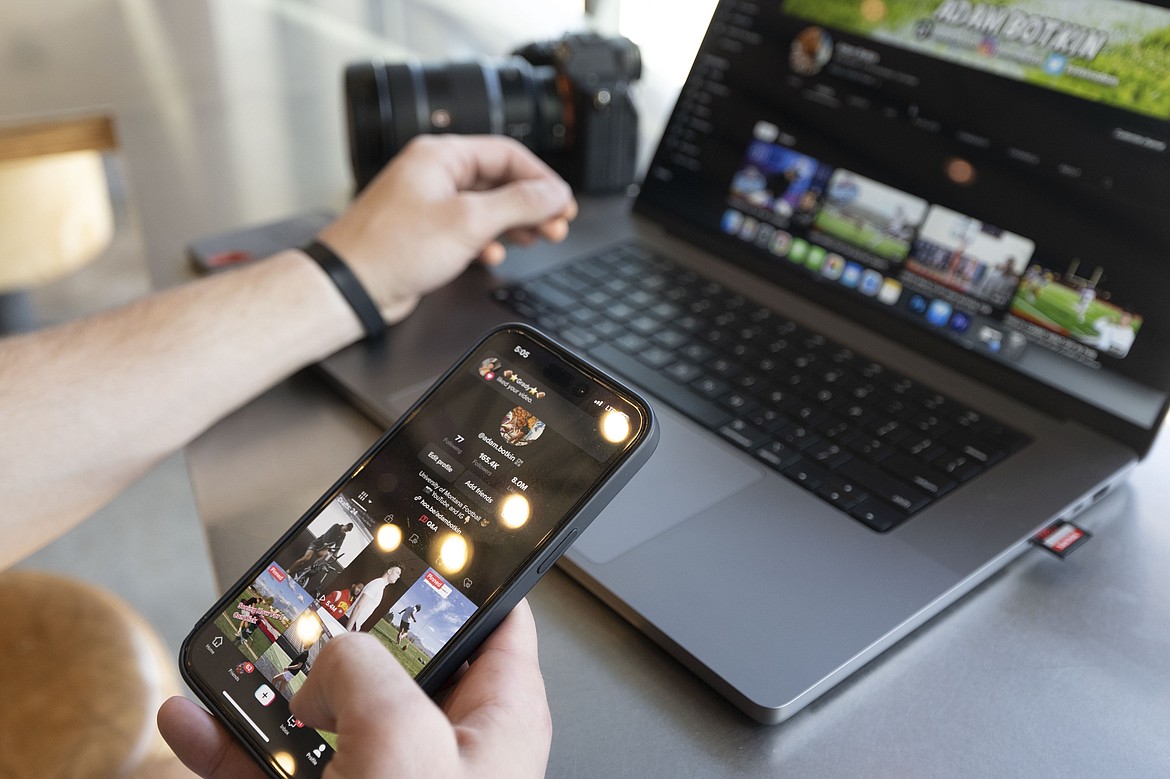 Adam Botkin, a football TikTok influencer, edits a video for a post at a Chipotle Mexican Grill while eating dinner in Missoula, Mont., on Wednesday, May 3, 2023. TikTok and five content creators who have filed lawsuits against the state arguing the ban is unconstitutional asked on judge on Wednesday, July 5, 2023, to issue a temporary injunction to block the law before it takes effect in January. ( (AP Photo/Tommy Martino, File)