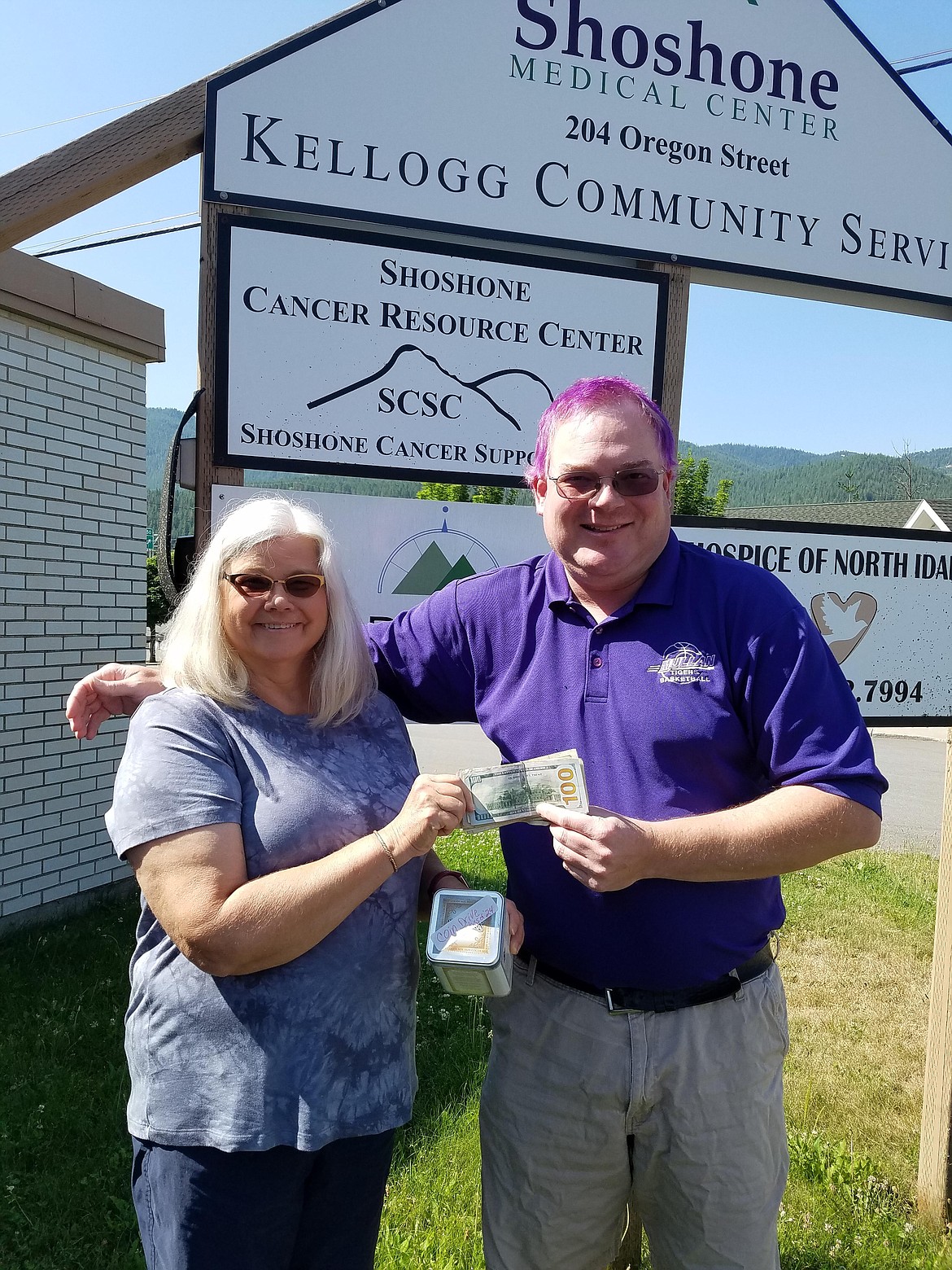 Valerie Jordan of the Shoshone Cancer Resource Center accepts the money from Mullan High School student council advisor and teacher Paul Elston. A total of $618.39 in funds was donated to Shoshone Cancer Resource Center as part of the Mullan High School coin drive.