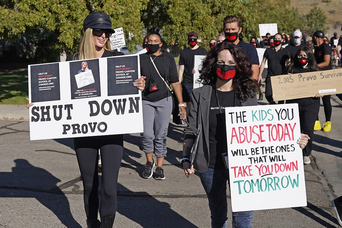 Paris Hilton, left, leads a protest on Oct. 9, 2020, in Provo, Utah. Hilton was in Utah to lead a protest outside a boarding school where she alleges she was abused physically and mentally by staff when she was a teenager. (AP Photo/Rick Bowmer, File)