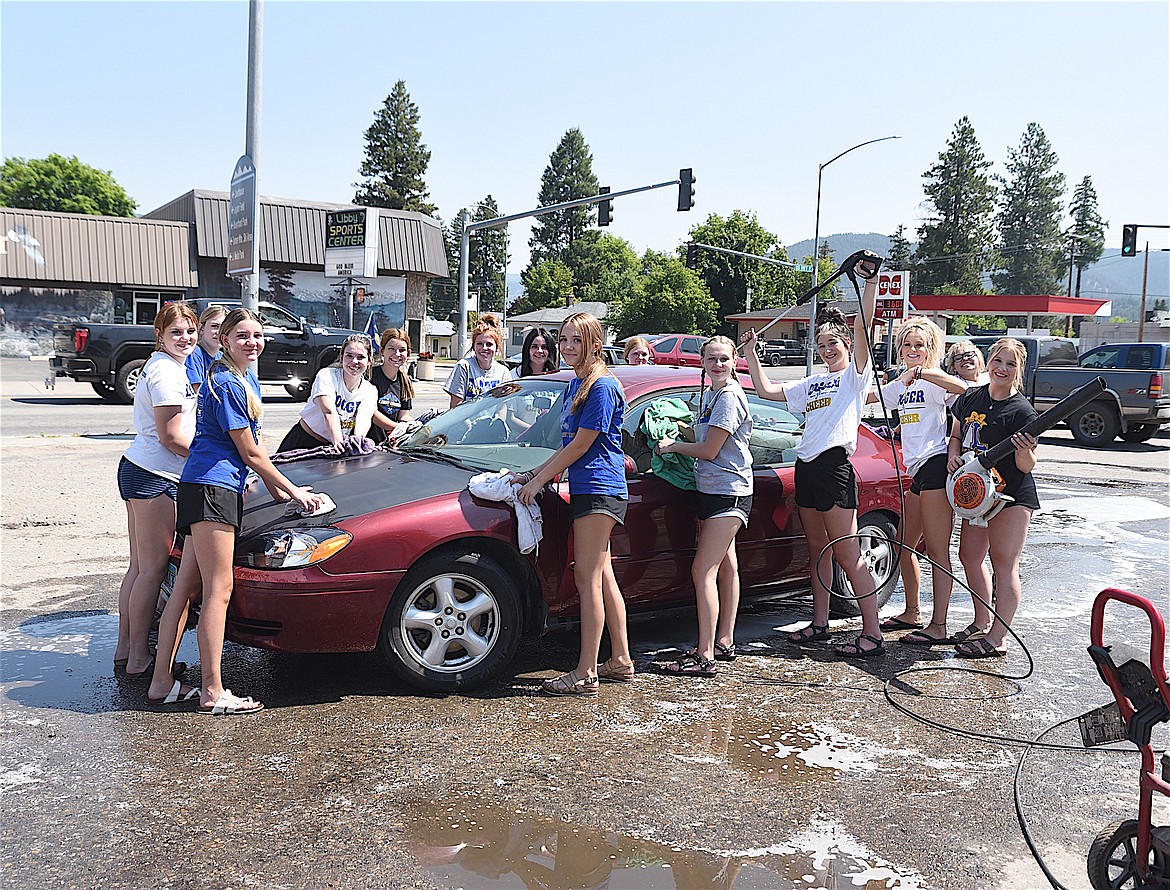 Members of the Libby High School cheer squad spent part of Saturday washing vehicles as part of a fundraiser. (Scott Shindledecker/The Western News)