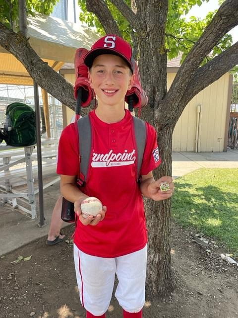Courtesy photo
Trevor Tadic of Sandpoint poses with the ball after hitting a grand slam in the third inning of a 14-3 win over Lakeland on Saturday in an Idaho Little League District 1 pool play game at Croffoot Park in Hayden. Henry Madden hit an RBI triple for Sandpoint, and Coen Leavitt, Kaleb Bogadi and Cruz Oliver all had run-scoring singles. Erik Hanson struck out seven in the game, called after four innings due to the 10-run rule. Sandpoint, which improved to 4-1 in pool play, plays Post Falls (2-3 in pool play) today at 12:15 p.m. at Croffoot Park on the final day of pool play. In other games Saturday, it was Coeur d’Alene 13, Post Falls 0, and Lewiston 10, Hayden 6. In other pool play finale games today at 12:15, Coeur d’Alene (5-0) plays Lewiston (4-1) at Canfield Sports Complex in Coeur d’Alene, and St. Maries (0-5) plays Lakeland (0-5) at Croffoot Park. Coeur d’Alene has outscored its five opponents 76-0. The top two teams following pool play will meet in a best-of-3 series July 14-16 at Croffoot Park for the District 1 title and a trip to the state playoff series in Boise vs. a District 2 team.