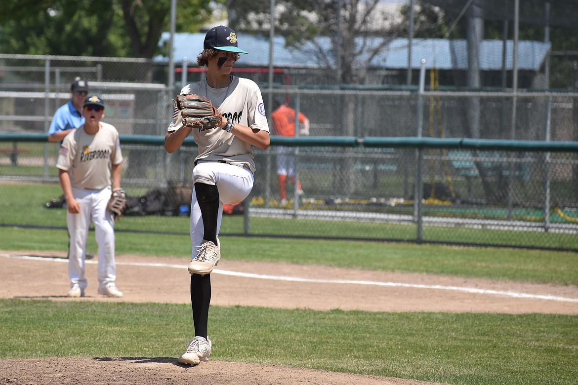 A pitcher for the 14U Columbia Basin River Dogs begins his pitching motion against Stilly Venom on Friday afternoon in Moses Lake.