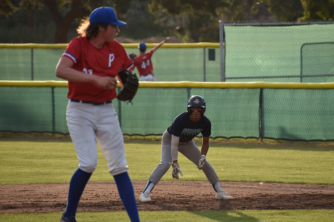 River Dog center fielder Jackson Carlos keeps his eyes locked on the pitcher before diving back to first base on a pickoff attempt.