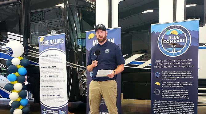 Blue Compass RV employee Evan Woolley touts how the company affected his life at a ribbon cutting and rebrand launch July 10 at the Post Falls location. Blue Compass is unifying its brand under one set of core values centered on customer experience and employees.