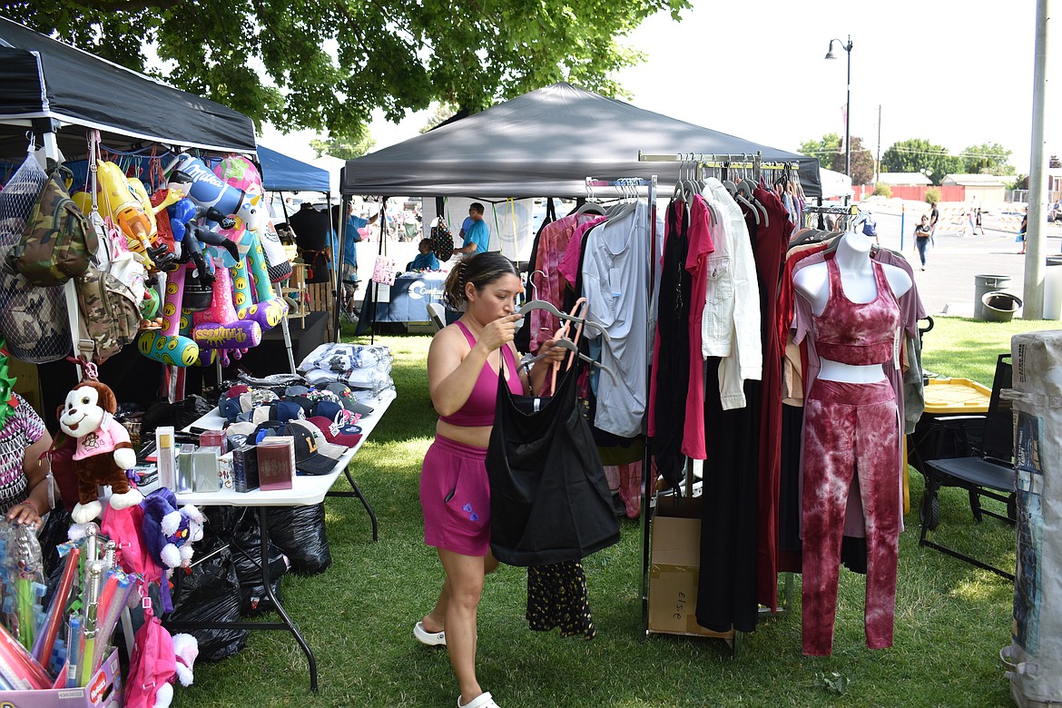 Maly Barajas, owner of Modern Mermaid, puts out merchandise at her booth as Summerfest is about to open Saturday morning. Barajas is originally from Royal City, she said, but now lives in Ephrata.