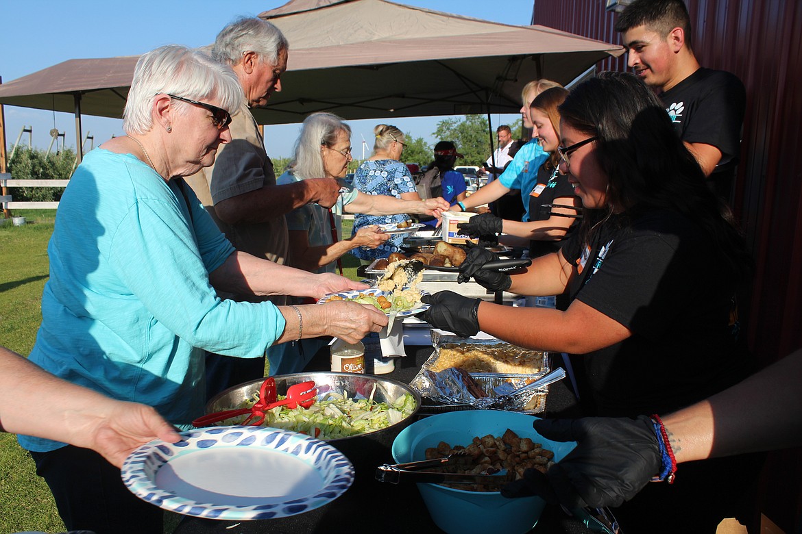 Adams County Pet Rescue staff serve dinner at the first Party for the Paws Saturday night.