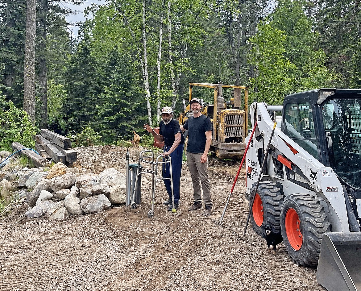 Gary Cabell and Jesse Miller stand near the wellhead of the newly installed well at Cabell's property in Whitefish. (Photo provided)