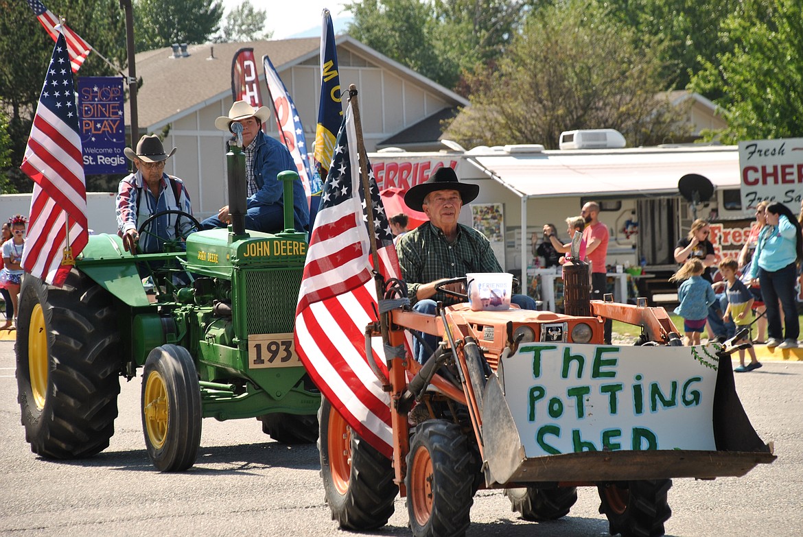 Milton Pearce, owner of the Potting Shed in St. Regis, drove his orange tractor in the parade. Behind him was Frank Smith, fellow St. Regis resident on his 1930s John Deere. (Mineral Independent/Amy Quinlivan)