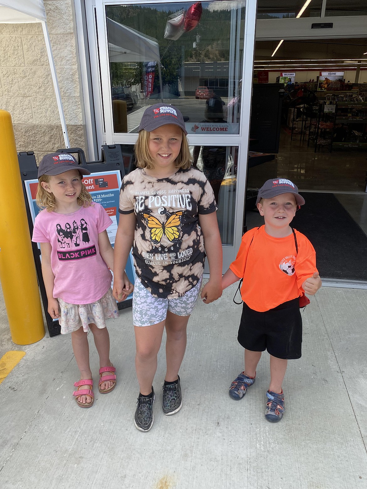 LilyMae, Aria, and Dayton Tryon, of Osburn, pose for a photo wearing their new Tractor Supply Company hats. A new Tractor Supply Co. location has opened at 207 West Cameron Ave., Kellogg.