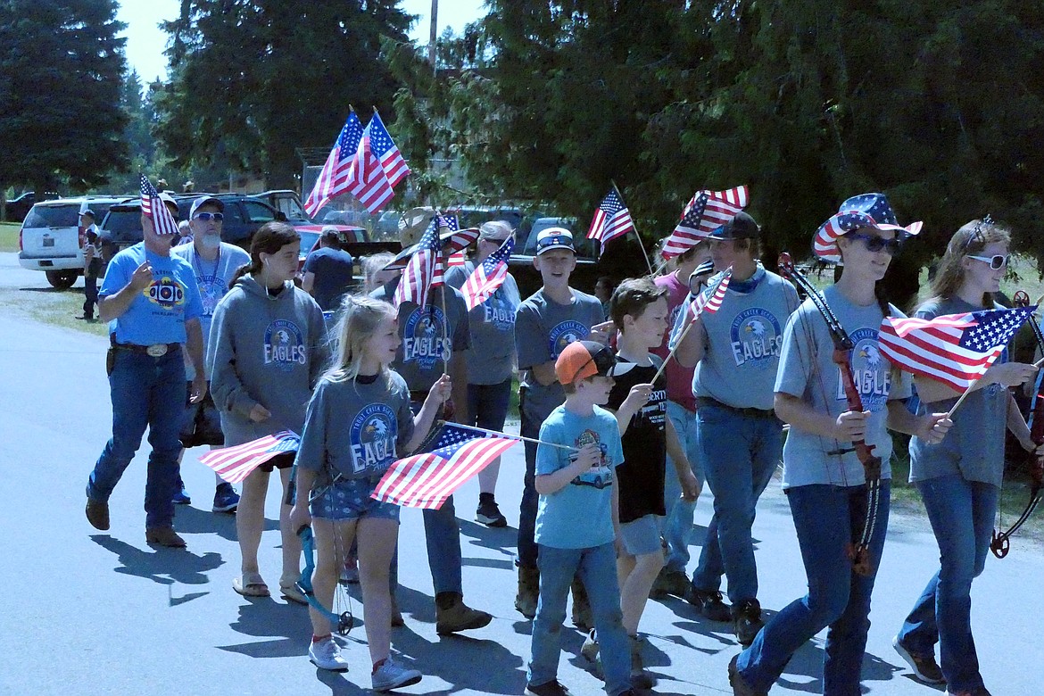 Archers from the Trout Creek archery team, which recently competed in the Western National finals tourney in Utah, march in Noxon parade this past Tuesday. (Chuck Bandel/VP-MI)