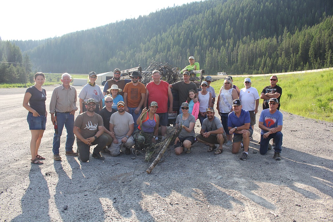 A portion of the volunteer wirepullers at the Taft exit on I-90 after their first day of removing wire near the Hiawatha Trail. A bull elk's rack is in the front showing the dangers this wire imposes on wildlife and the reason the Rocky Mountain Elk Foundation organizes the two-day removal around the Fourth of July annually. (Monte Turner/Mineral Independent)