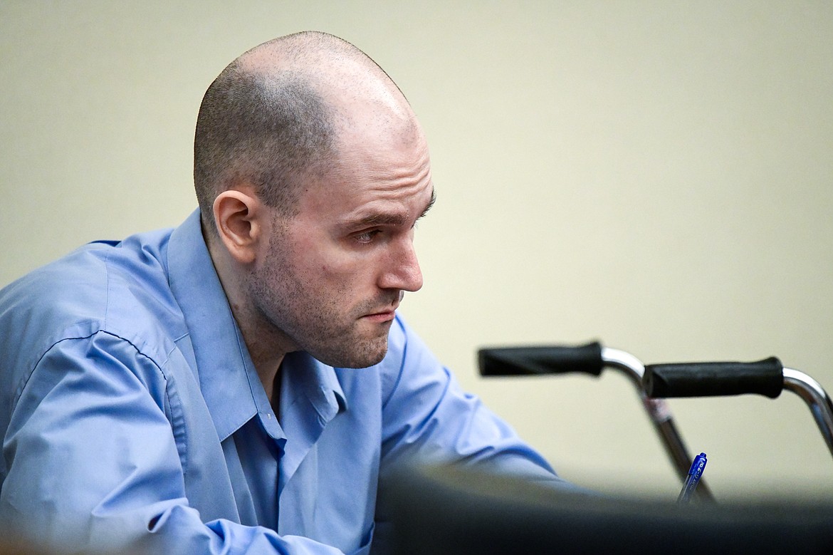 Jonathan Douglas Shaw talks with his defense team before a recess in his murder trial in Flathead County District Court in Kalispell on Tuesday, July 11. (Casey Kreider/Daily Inter Lake)