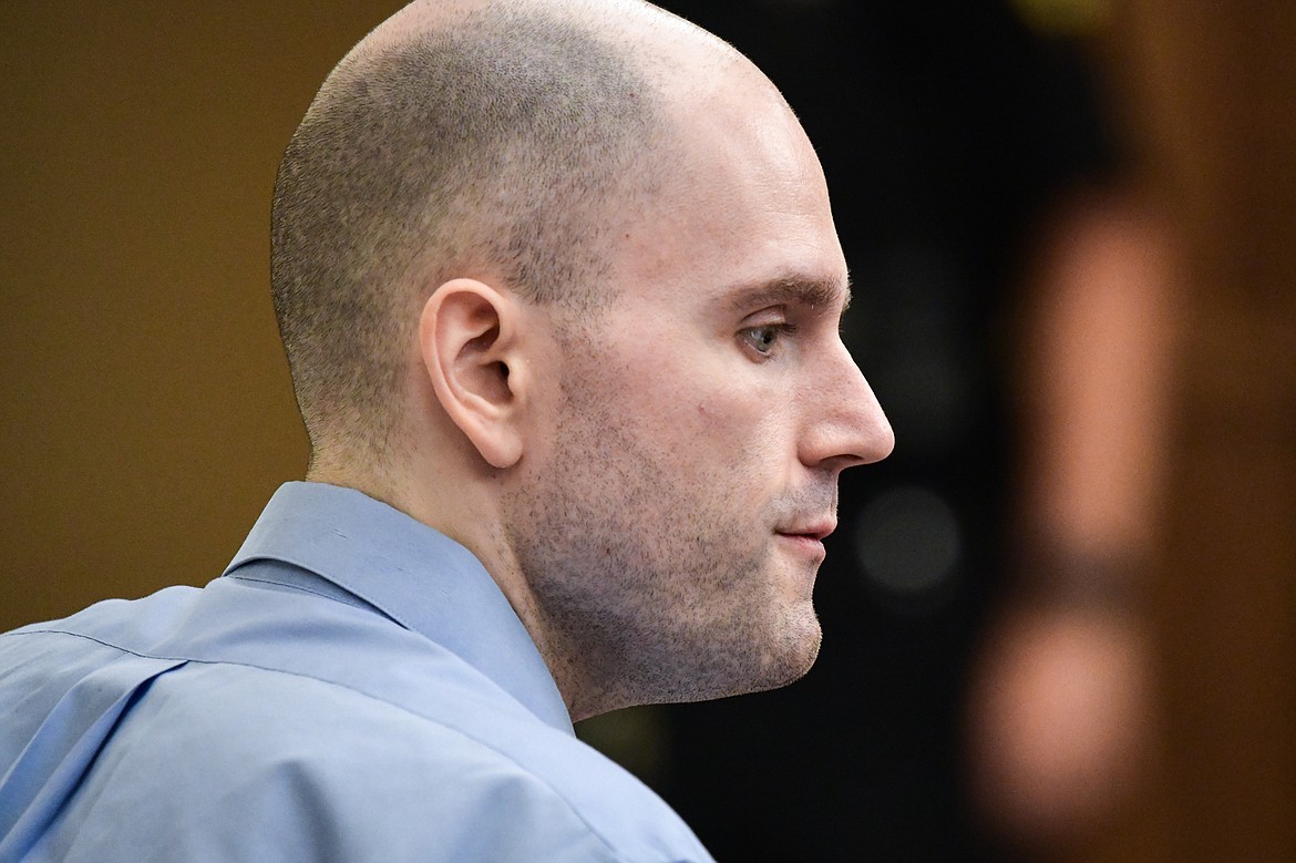 Jonathan Douglas Shaw talks with his defense team before a recess in his murder trial in Flathead County District Court in Kalispell on Tuesday, July 11. (Casey Kreider/Daily Inter Lake)