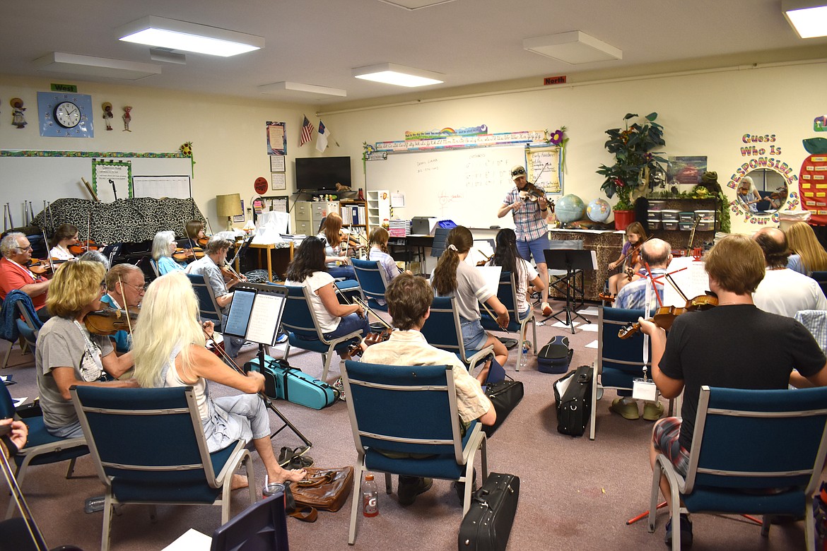 Dennis Ludiker leads the Hot Shots fiddle class at the Washington Old Time Fiddlers Fiddle Camp Tuesday. Ludiker, a Spokane native, is something of a hot shot himself, having won several fiddling championships and performed with the South Austin Jug Band and Asleep at the Wheel, according to his website.